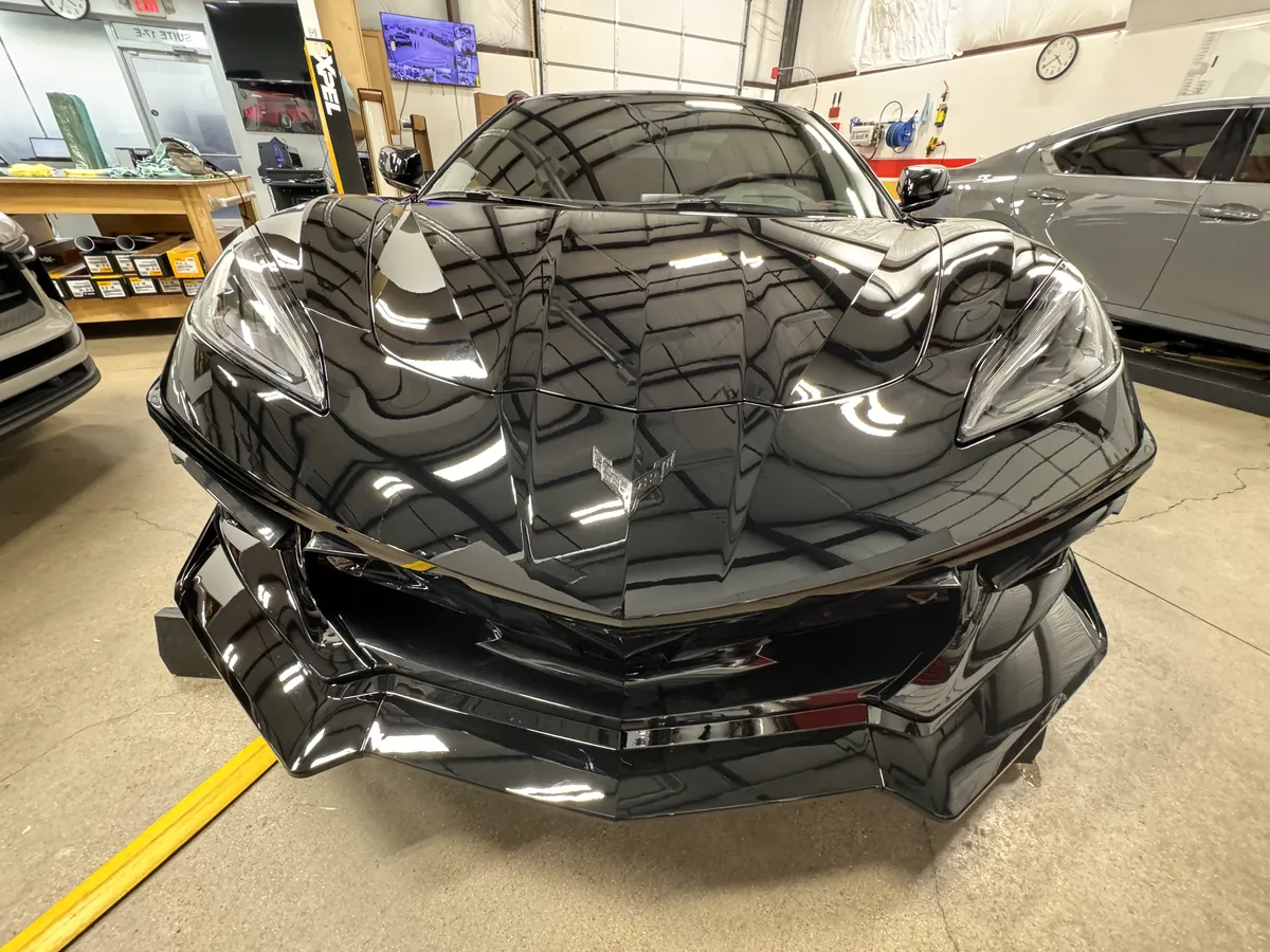 Corvette paint protection film application process showing front bumper and hood coverage in Argyle Texas